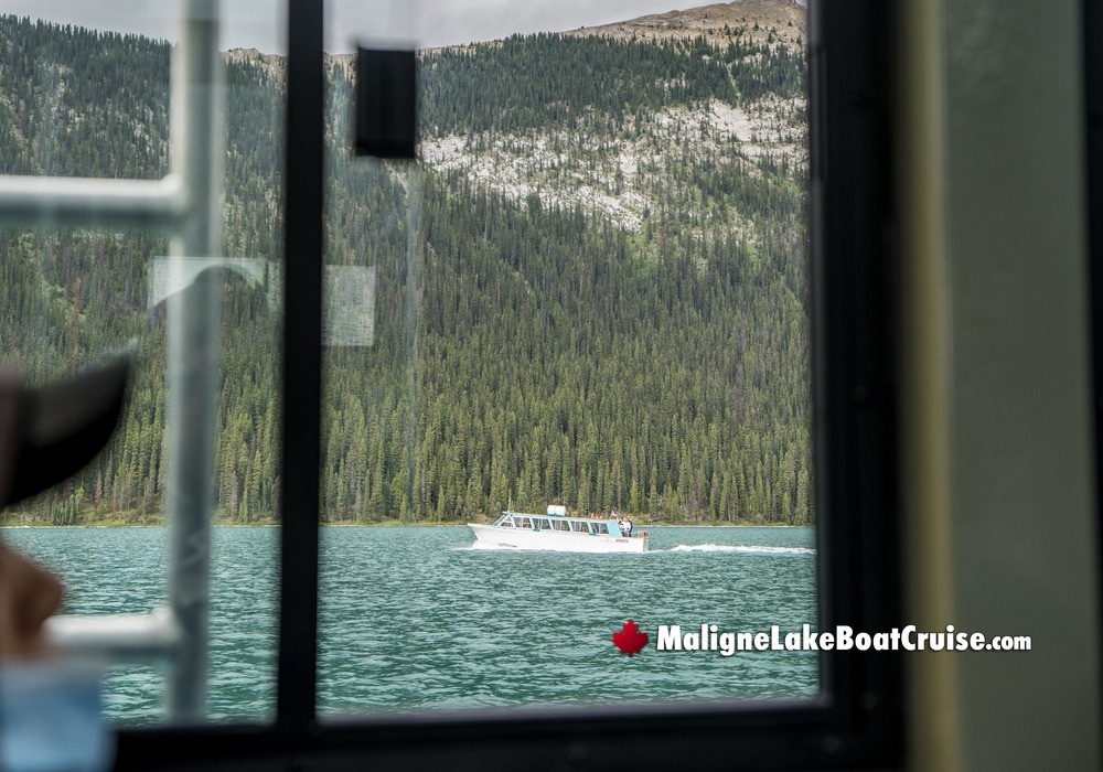Boat Passing By Window on Maligne Lake